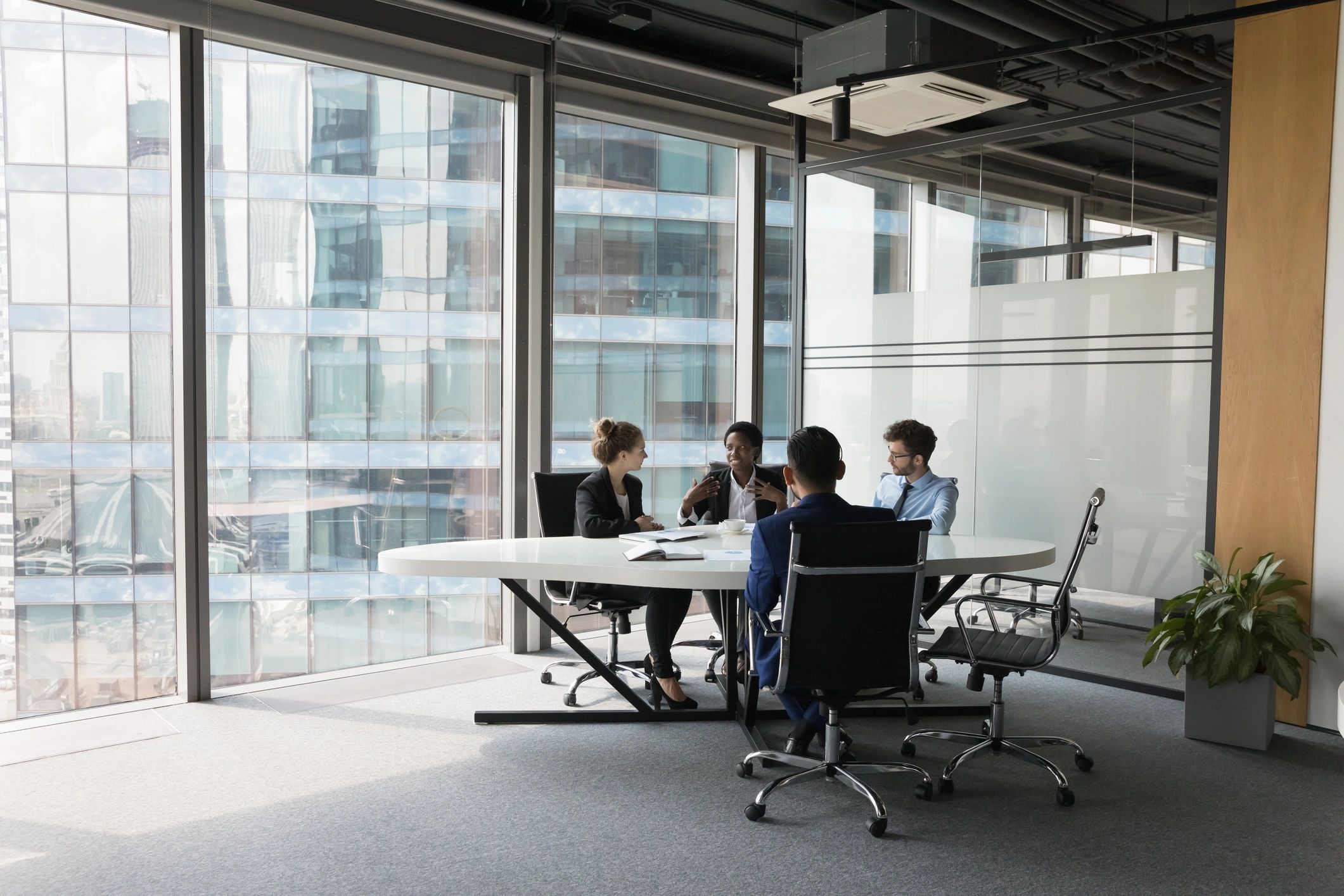 Socio Cyber leadership team collaborating in a modern meeting room